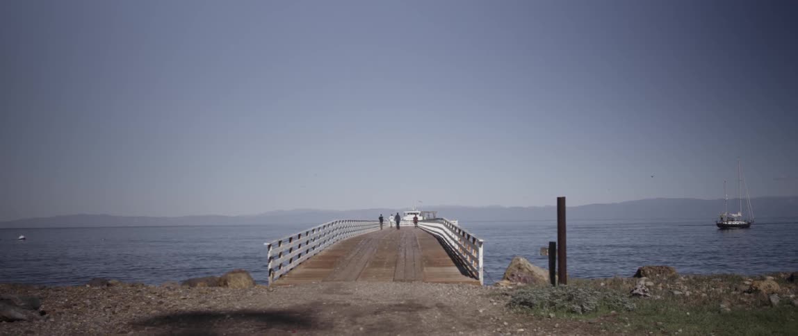 People are walking along the boardwalk ahead