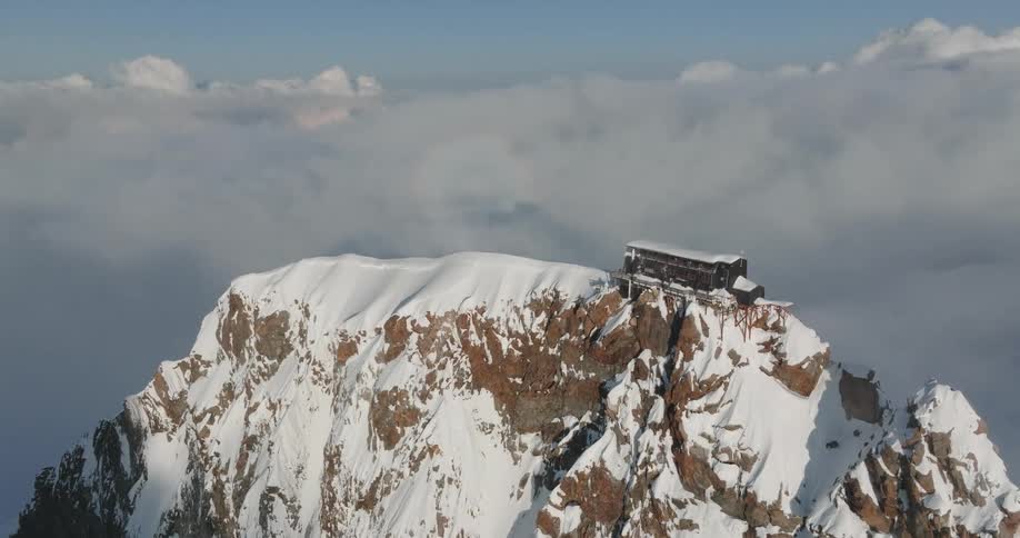 A house on top of a snowy mountain during the day