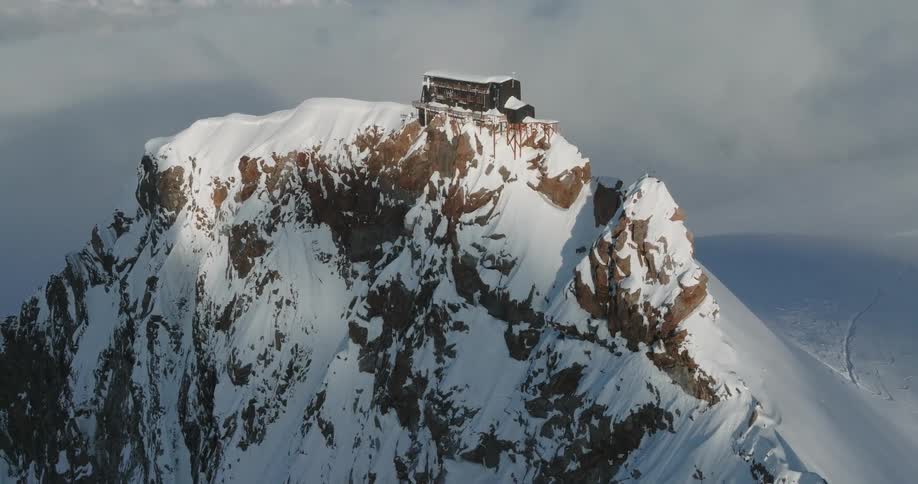 Cottage on a mountain covered in snow in daytime