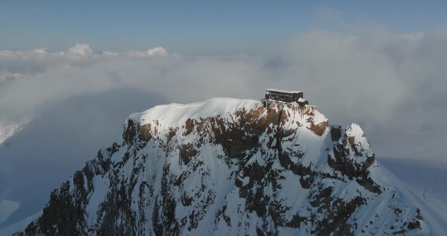 A shelter is on the peak of the mountain