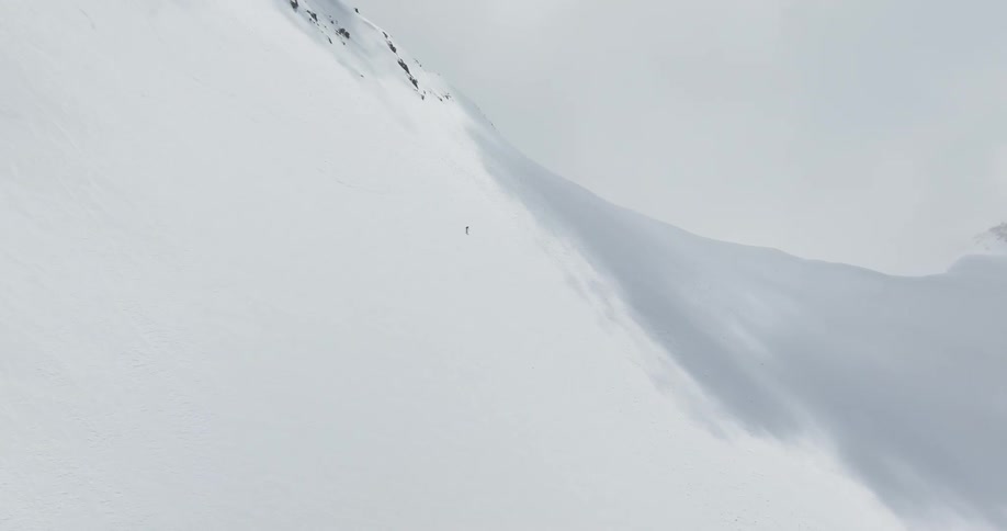 A person skiing on a snowcovered mountain during the winter