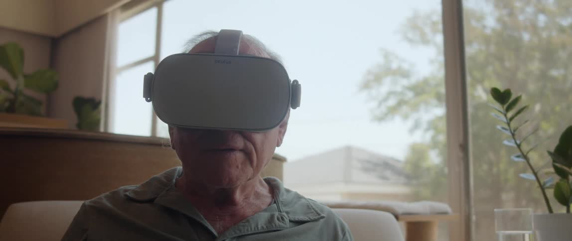 Elderly man tries virtual reality goggles at home