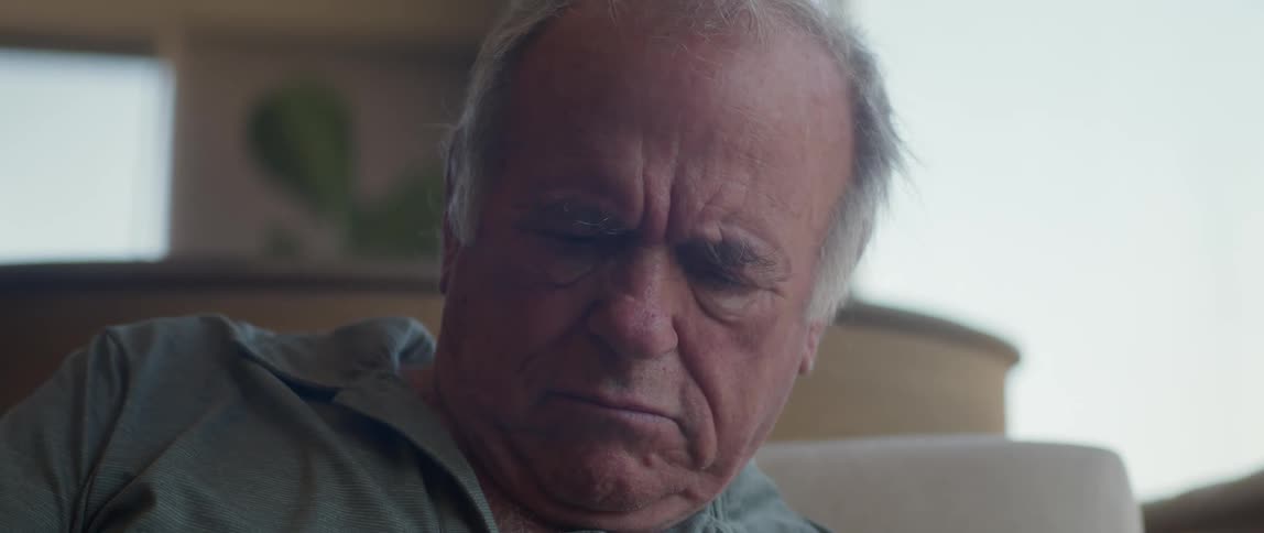 Man sits and frowns while concentrating at home