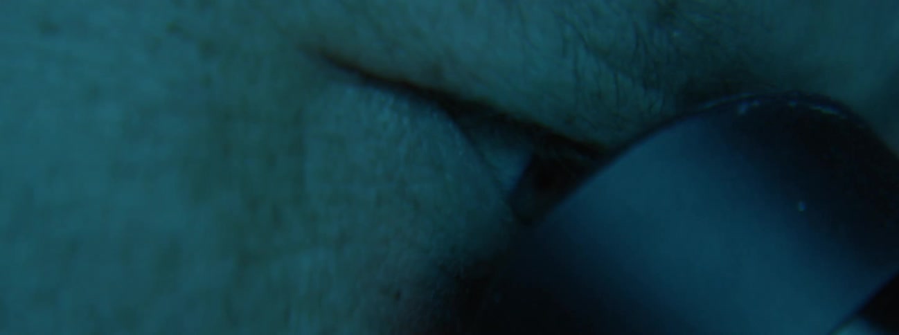 Man looks into microscope eyepiece