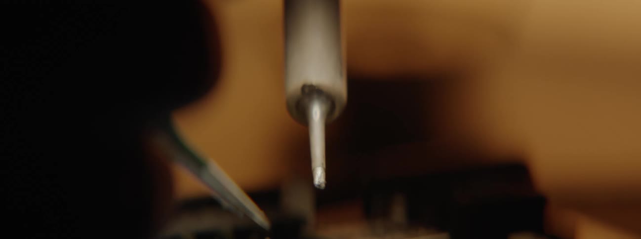 Extreme closeup of soldering and reballing tools on a hardware component