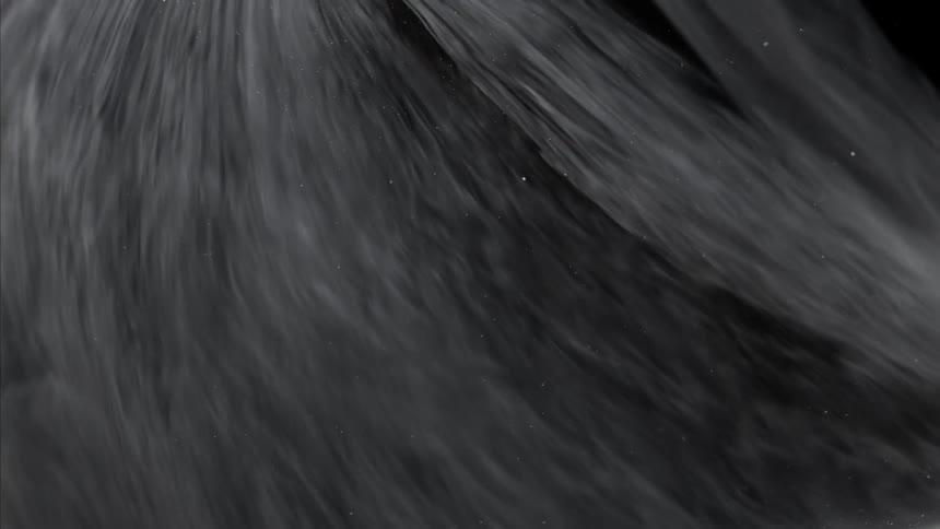 Dark mixture streaked with shades of gray flows along