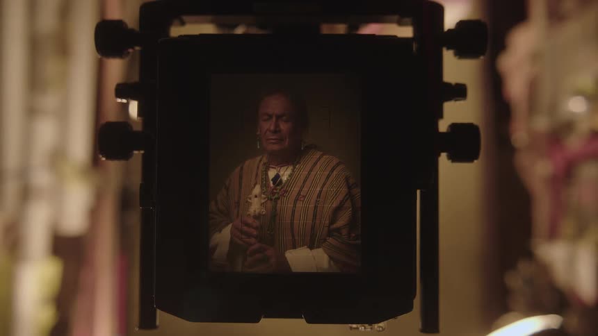 A man captured in an ancient photographic image device illuminated by a bright flash