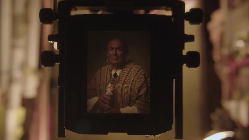 Closeup of a camera taking a photo of a man from the indigenous tribe