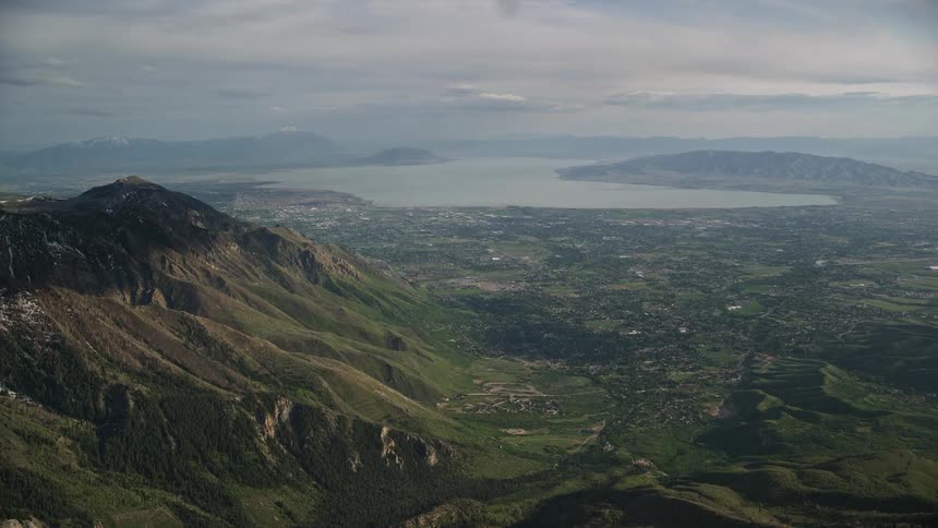 Aerialfootage of American Fork Utah Lake from Wasatch Range showcasing the mountains lake and city