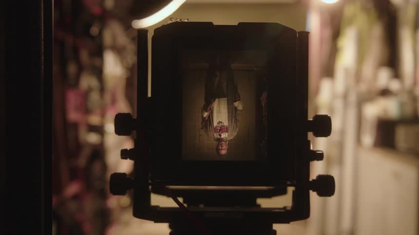 A man has his photograph taken with a camera