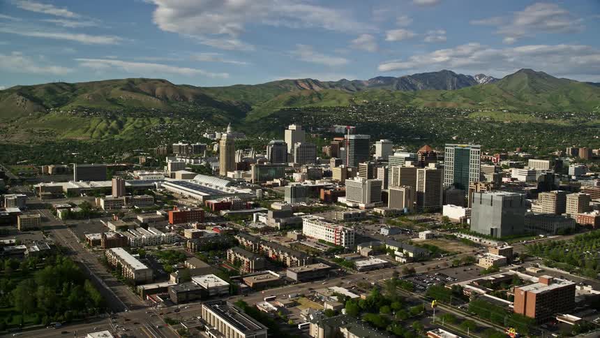 A stunning aerial view of Salt Lake City Utah with the Wasatch Range in the background on a sunny day