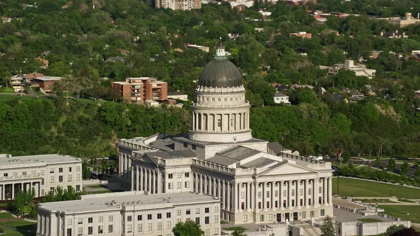 Aerial footage of the Utah State Capitol on Capitol Hill in Salt Lake City Utah showcasing the stunning architecture and scenic surroundings during a sunny day