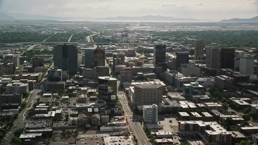 A mesmerizing aerial shot showcasing the bustling downtown streets and towering buildings of Salt Lake City Utah during a sunny summer day