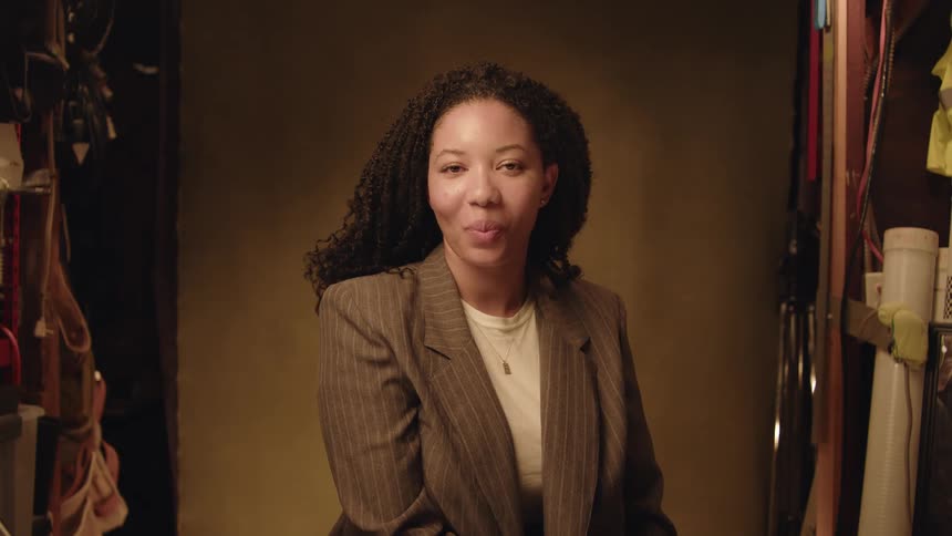 Portrait of a woman staring ahead giving a beautiful smile and then returning to a neutral expression