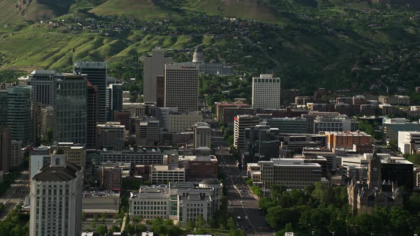 Aerial view of Downtown Salt Lake City Utah's city streets including State Street and Main Street with office buildings and mountains in the background