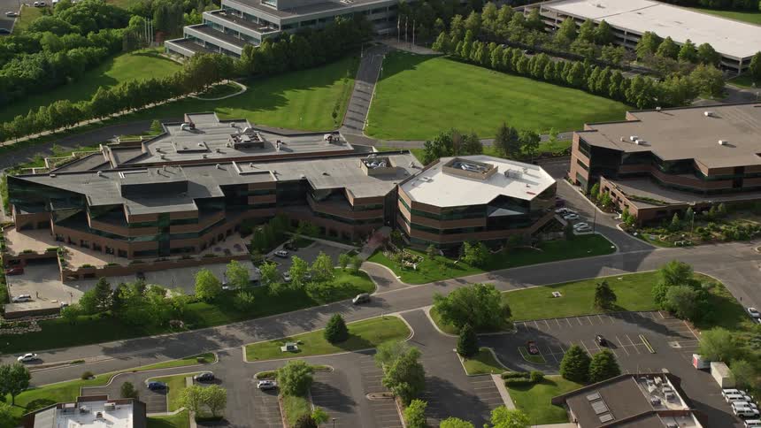 Aerial view of University of Utah office buildings in Salt Lake City Utah approached during the day with a tilt down perspective