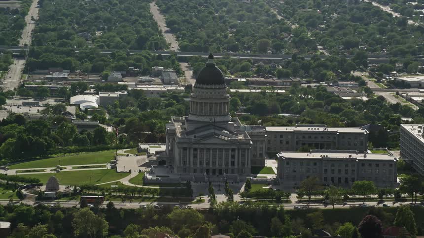 Aerial footage circling around Utah State Capitol a classical building with a domed tower on Capitol Hill Salt Lake City Utah during a sunny day in summer