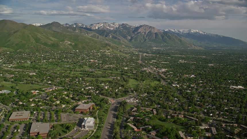 Aerial footage of suburban neighborhoods in Salt Lake City Utah with the Wasatch Range mountains in the background
