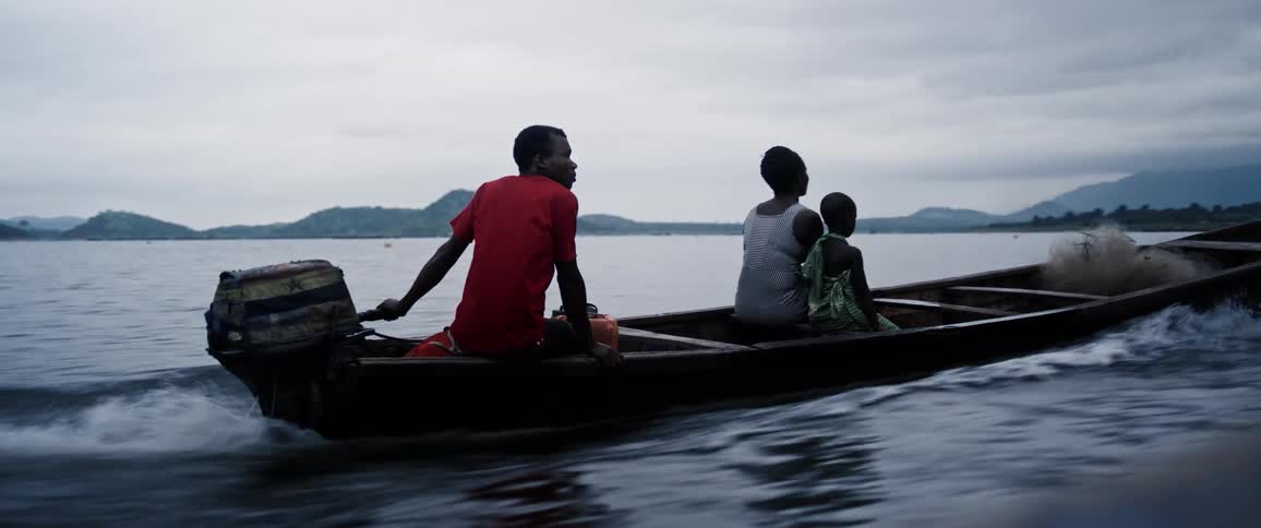 Man woman and a child inside a moving canoe on a river