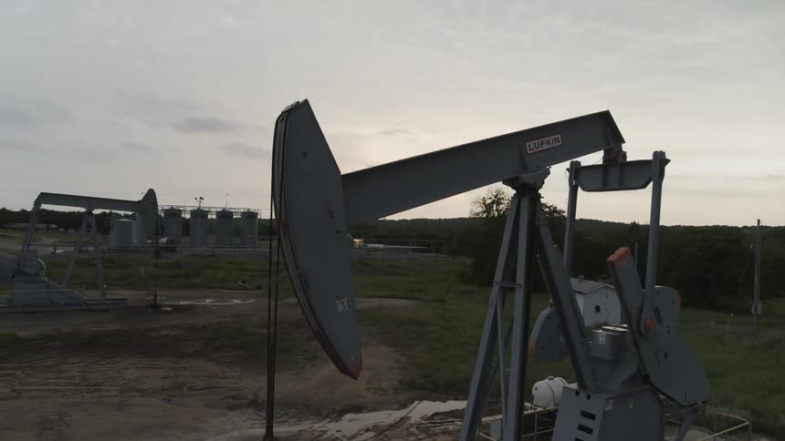 Slow orbit around a large pumpjack working the oil field