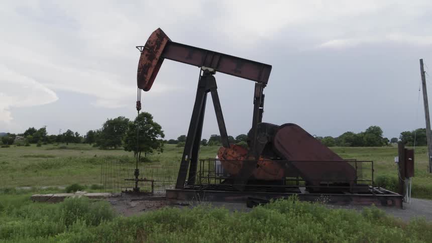 Slow orbit around a pumpjack extracting crude oil from underground