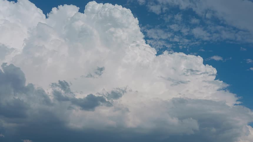 Clouds move left across blue sky