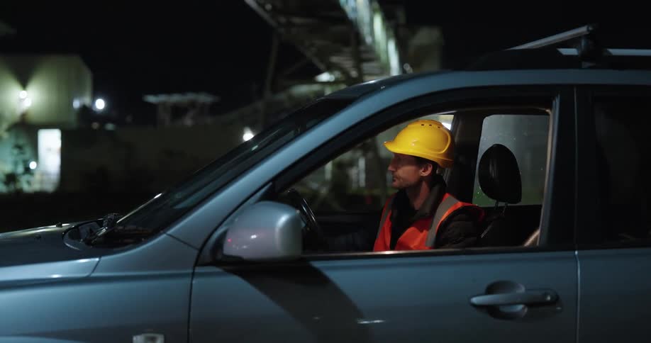 Man putting on his protective helmet and getting out of the vehicle he was sitting in
