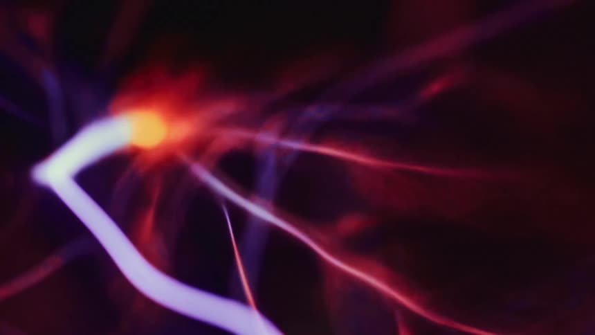 Static bolts flex against a dark background in plasma lamp
