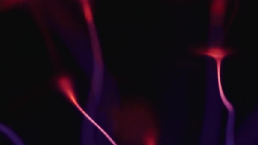 Strings of glowing purple lights at night