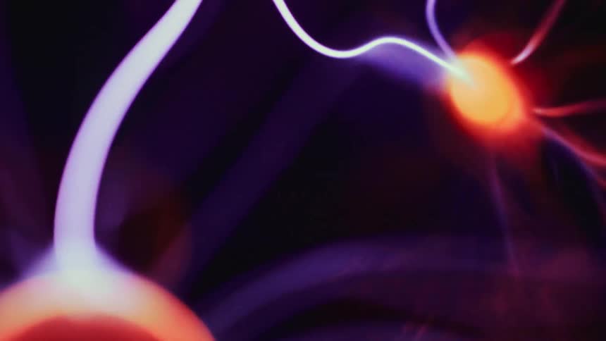 Neon lights move around in a plasma ball