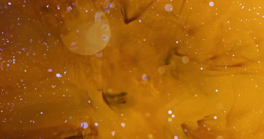 Liquid texture in abstract of a bubble bursting inside yellow liquid