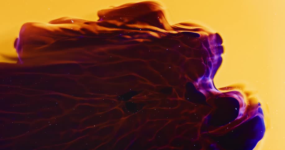 Dense liquid with various colors and a shimmering effect moving slowly on a yellow and abstract background