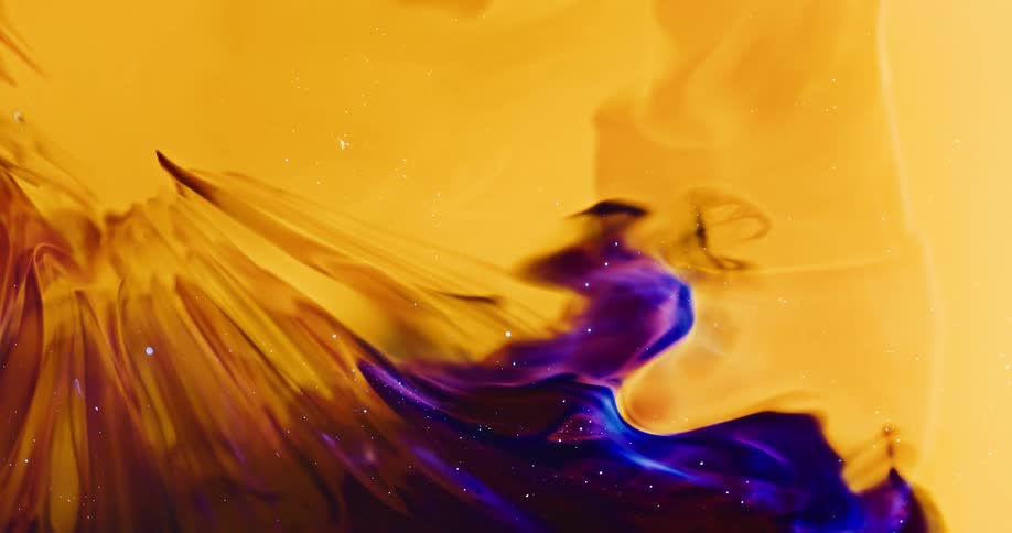 Shimmering black and blue ink bubble bursting within a dense yellow liquid in an abstract manner
