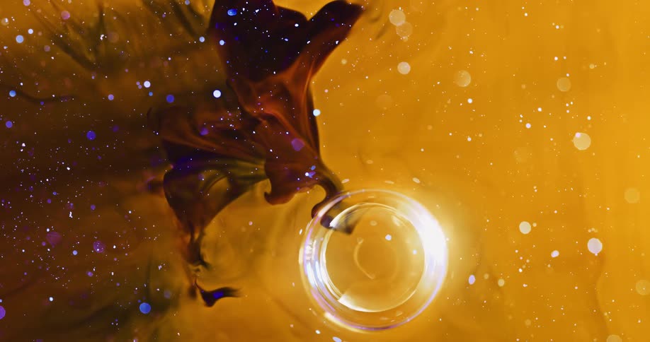 Special effect of a luminous bubble moving slowly through a vast expanse of abstract yellow and purple liquids