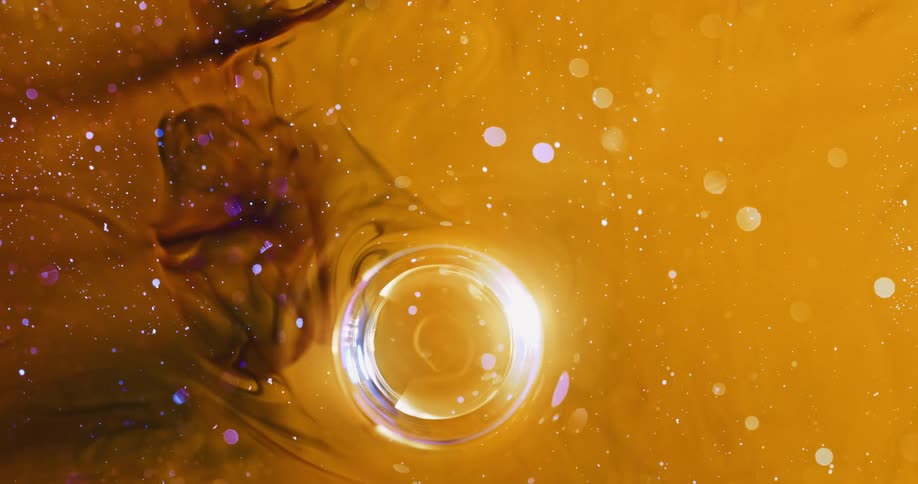 Small sparkling bubble moving in an abstract manner within a dense yellow liquid