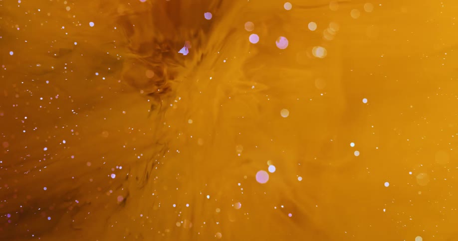 Abstract smoke and colorful particles in a yellow space of liquid