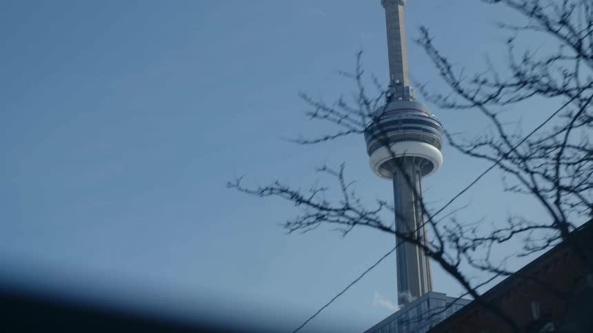 Camera pointed upwards capturing a view of a towering structure on a cloudless day with a blue sky