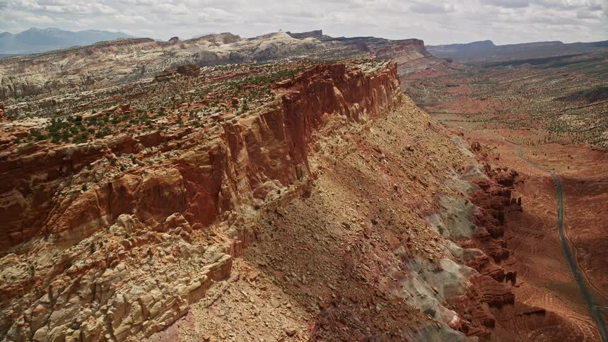 Aerial footage of a mesa in Capitol Reef National Park Utah with stunning rock formations and a sunny desert landscape