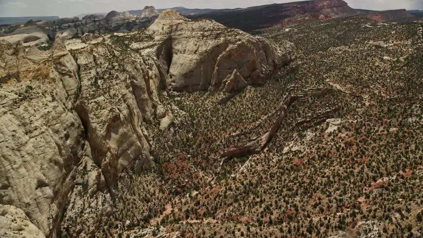  aerial footage of approaching the Waterpocket Fold rock formations panning to reveal the breathtaking canyon of Capitol Reef National Park in Utah