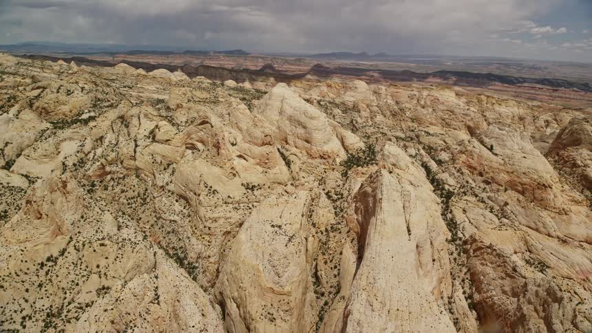 Aerial footage showcases the stunning rock formations and unique landscape of Capitol Reef National Park Utah with partly cloudy skies and a panoramic view