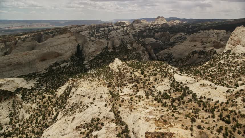 Approaching the iconic Waterpocket Fold rock formations in Capitol Reef National Park Utah with partly cloudy skies creating beautiful shadows over the landscape