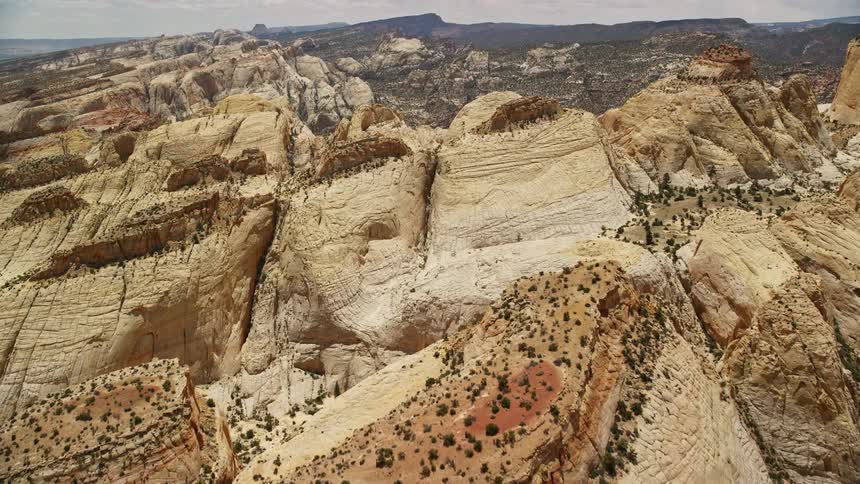 A stunning aerial view of the rugged rock formations and scenic landscapes of Capitol Reef National Park in Utah during a sunny summer day