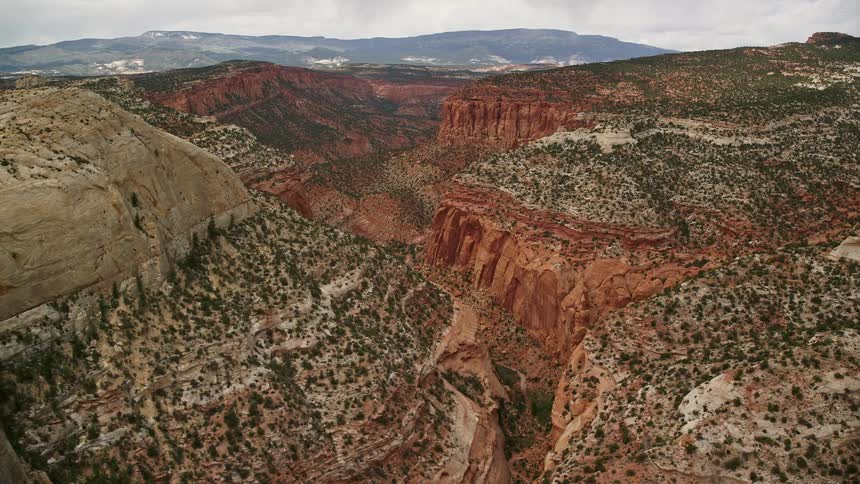  aerial footage of steep and tall canyons mesas and the Waterpocket Fold in Capitol Reef National Park Utah showcasing the arid and famous desert landscape