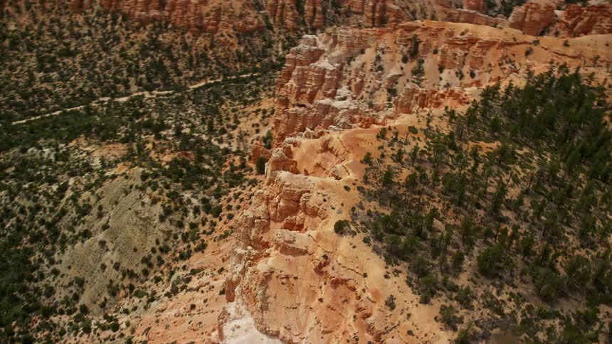Aerialfootage showcasing the majestic Bryce Canyon National Park in Utah featuring the iconic hoodoos and stunning rock formations with cloudy skies overhead