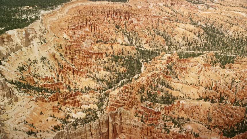 Aerial footage of circling groups of hoodoos and buttes in Bryce Canyon National Park Utah showcasing the stunning rock formations and arid landscapes