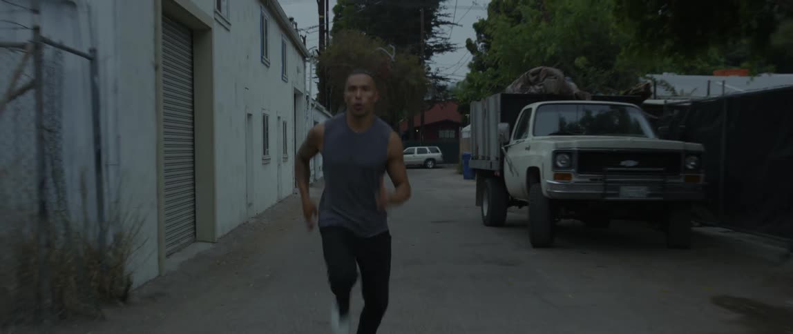 Man running in a small street at dawn