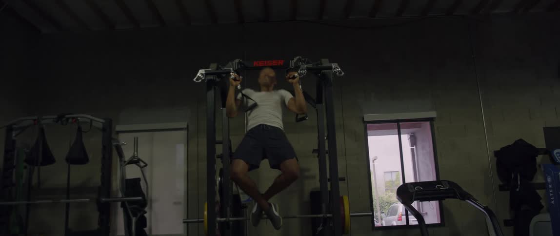 Man working out inside the gym during the day