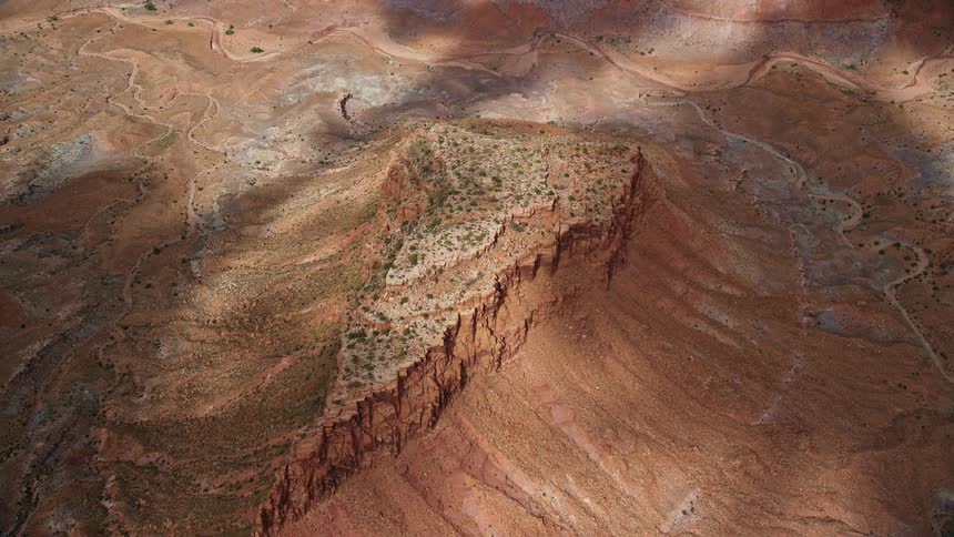 Aerial footage showcasing cloud shadows over mesas in the desert providing a unique bird's eye view of the landscape in the Navajo Nation Reservation Arizona and Utah