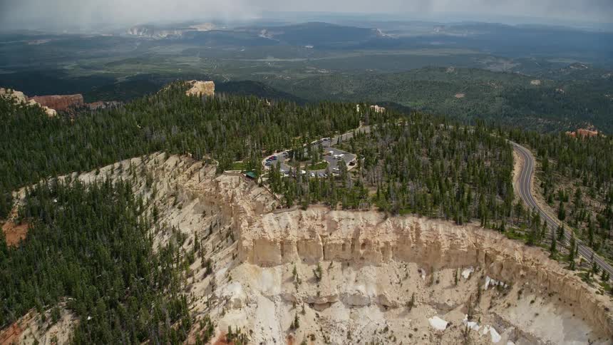 Approaching Rainbow Point in Bryce Canyon National Park Utah flying over the famous rock formations and limestone cliffs with partly cloudy skies