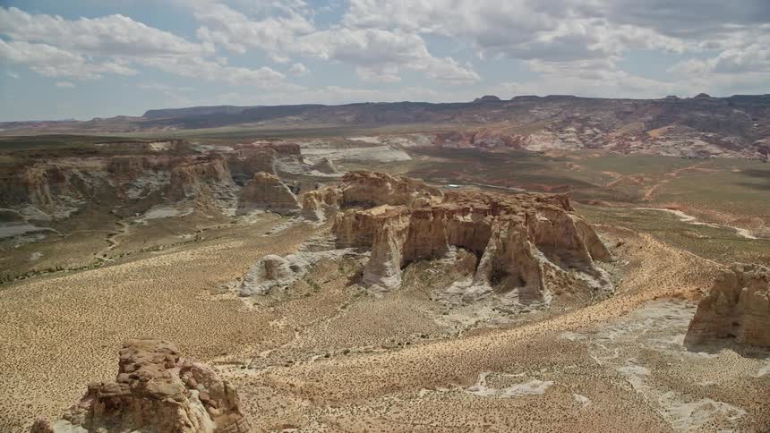 Aerial view of rocky buttes and plateaus in the Southwest United States showcasing the stunning desert landscape of Glen Canyon National Recreation Area on a bright summer day